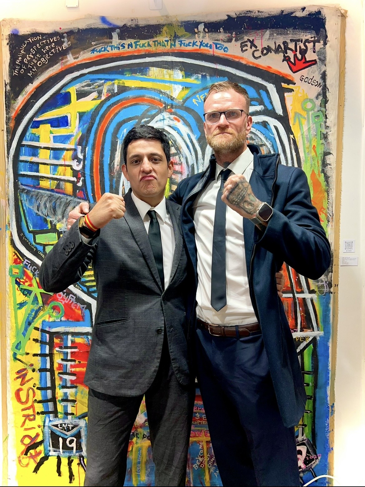 R.P. Gribben with a fellow attendee in front of a large exhibited painting